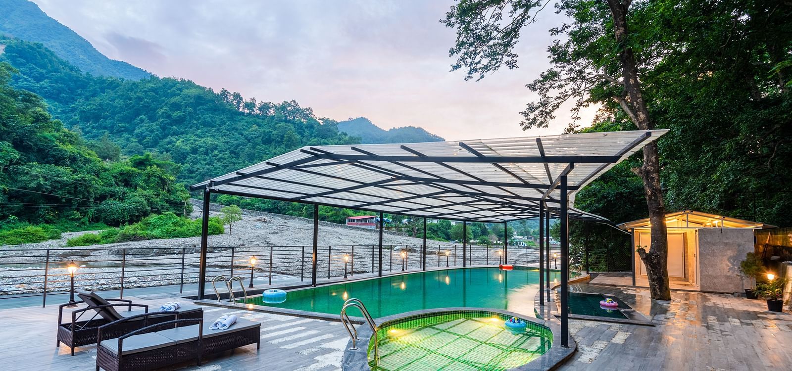 A swimming pool at DLS Divine River Resort and Spa with panoramic views and lounge chairs 